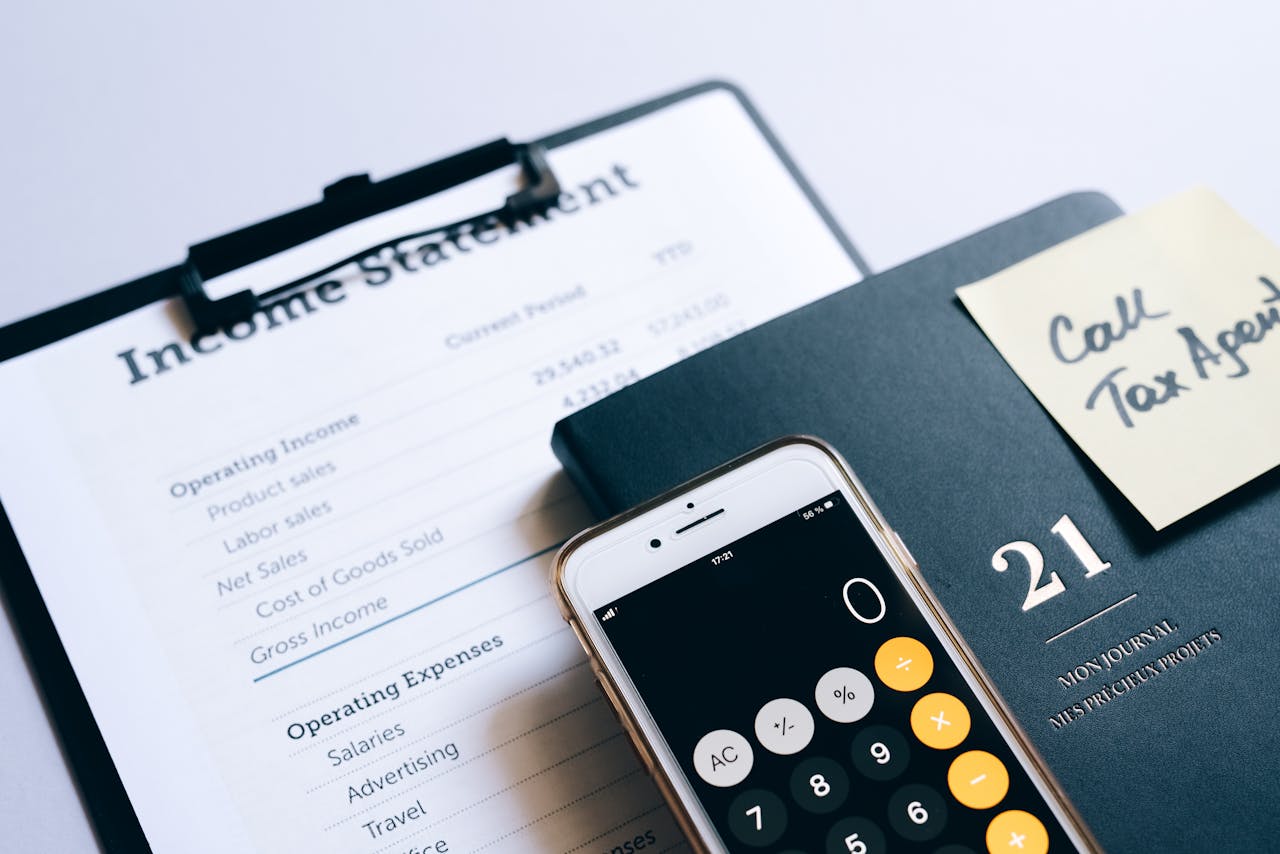 The Art of Drawing Readers In: Your attractive post title goes here Close-up of income statement, calculator, and planner for financial planning.